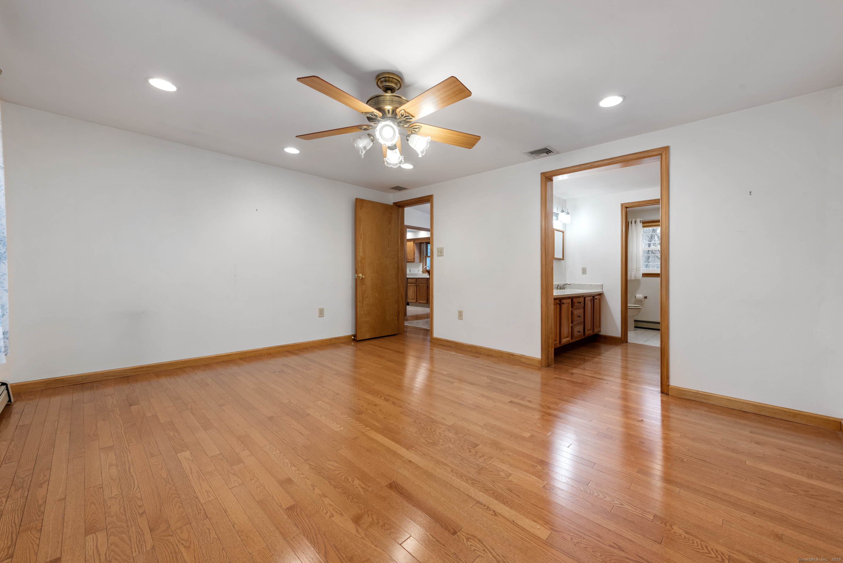 56 Great Hill Road Seymour, CT 06483 - Photo 17 of 40 a view of an empty room with wooden floor and a ceiling fan