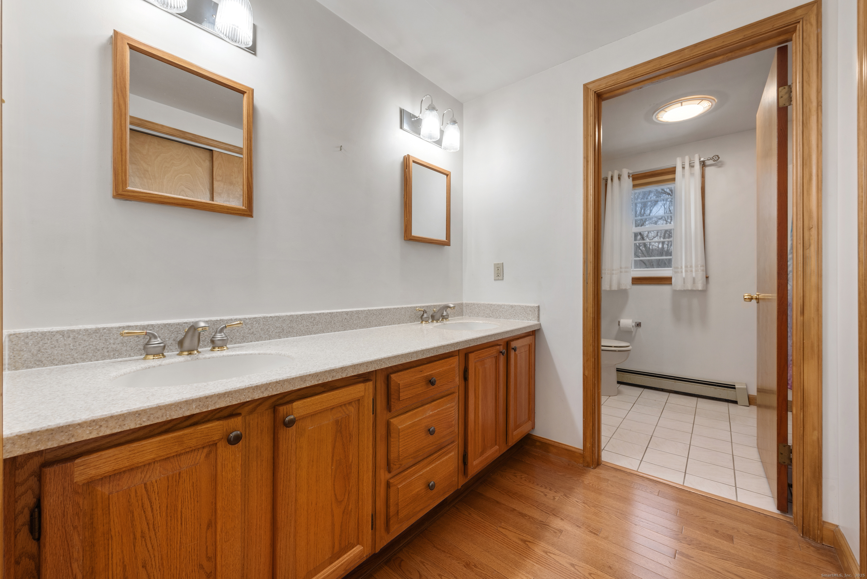 56 Great Hill Road Seymour, CT 06483 - Photo 20 of 40 a spacious bathroom with a double vanity sink and a mirror