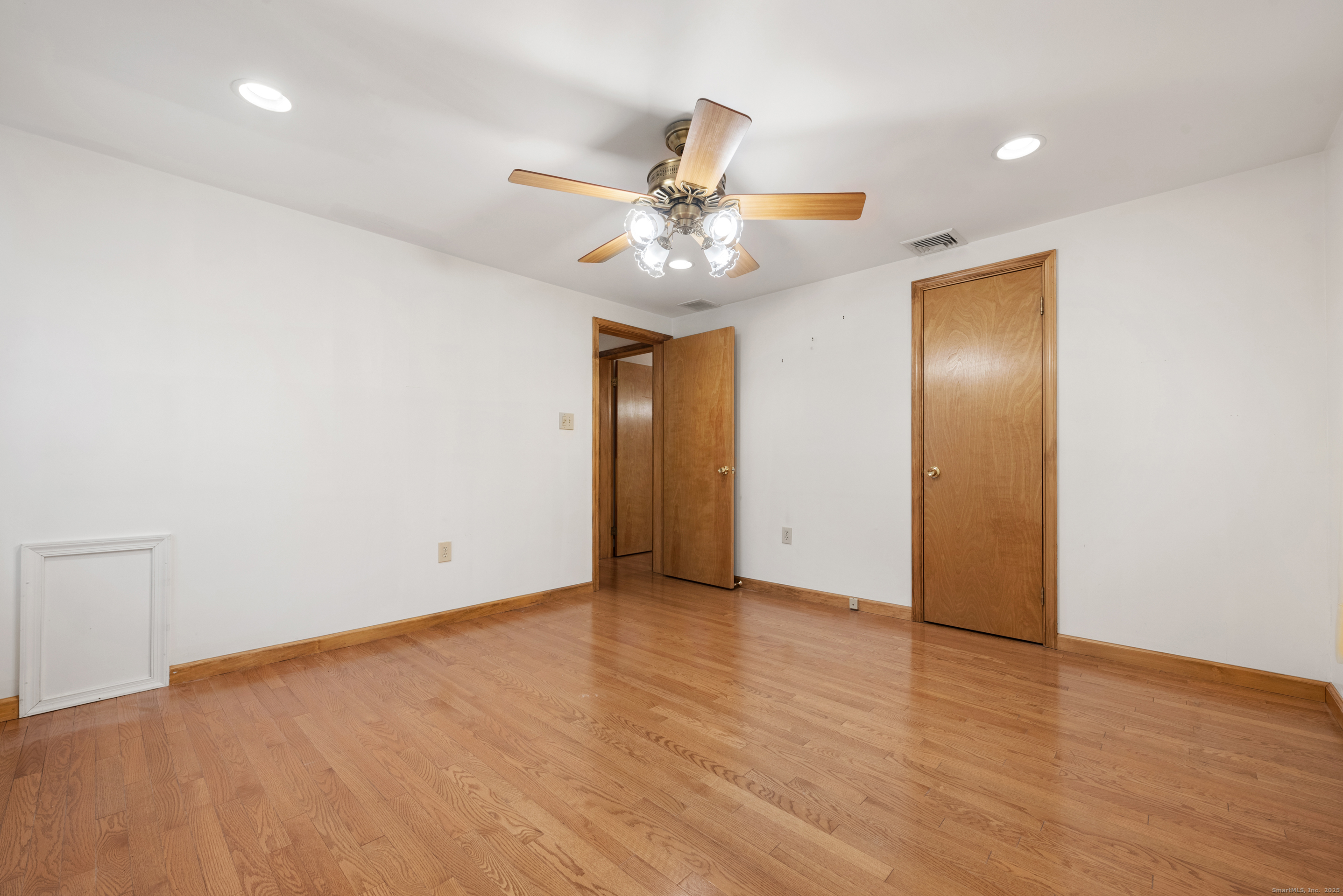 56 Great Hill Road Seymour, CT 06483 - Photo 23 of 40 an empty room with wooden floor a ceiling fan and closet