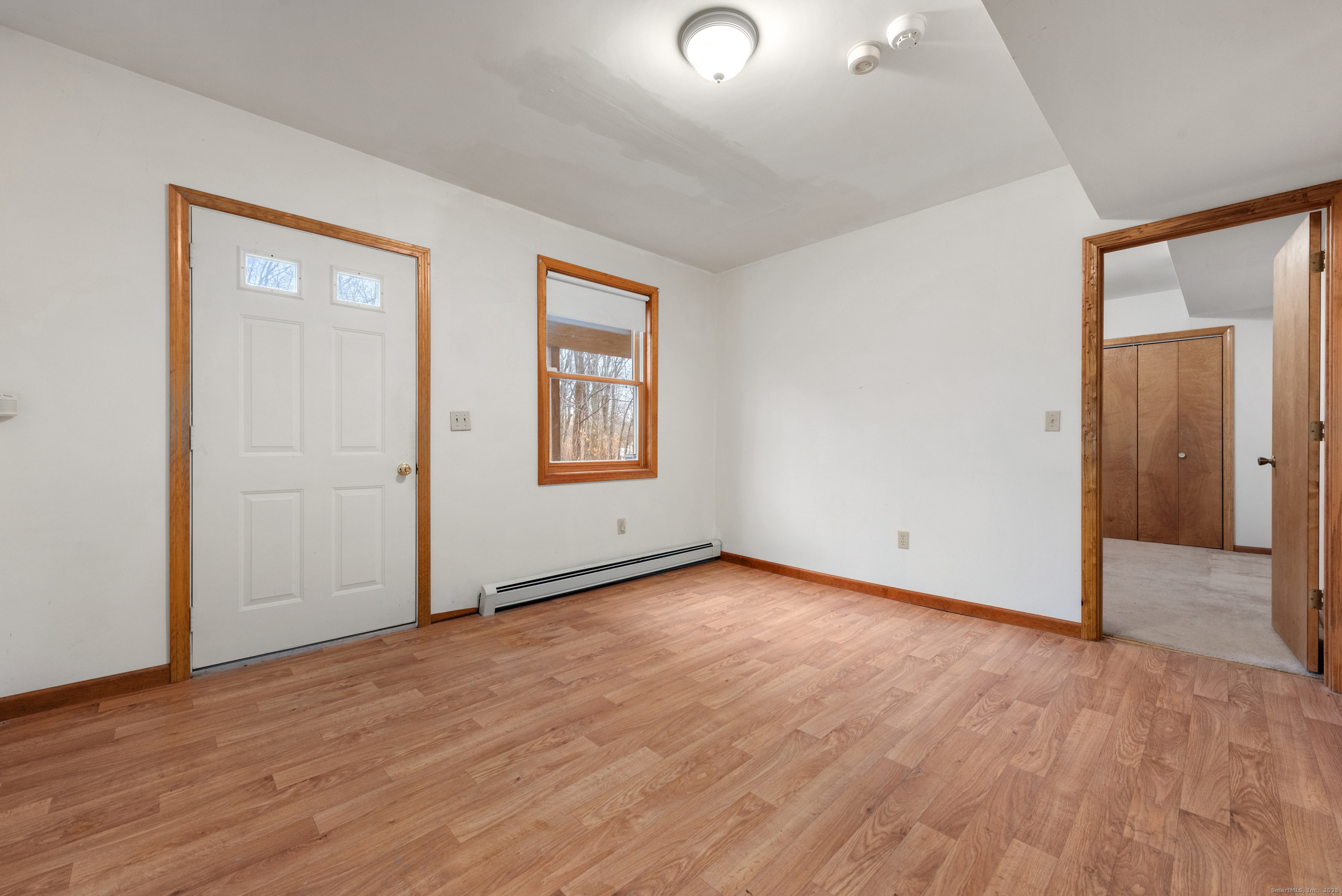 56 Great Hill Road Seymour, CT 06483 - Photo 29 of 40 an empty room with wooden floor and windows