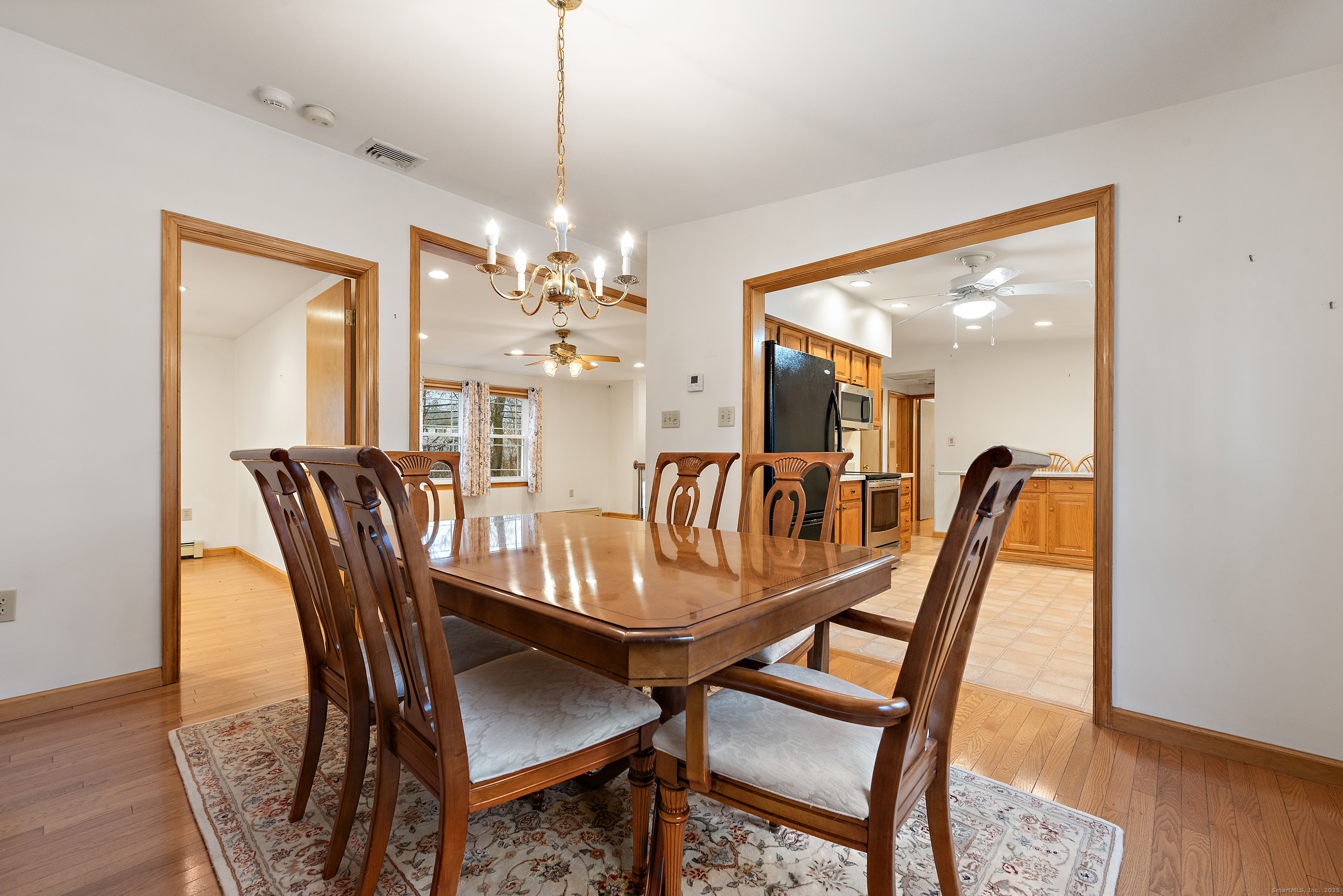 56 Great Hill Road Seymour, CT 06483 - Photo 8 of 40 a dining room with furniture a chandelier and wooden floor