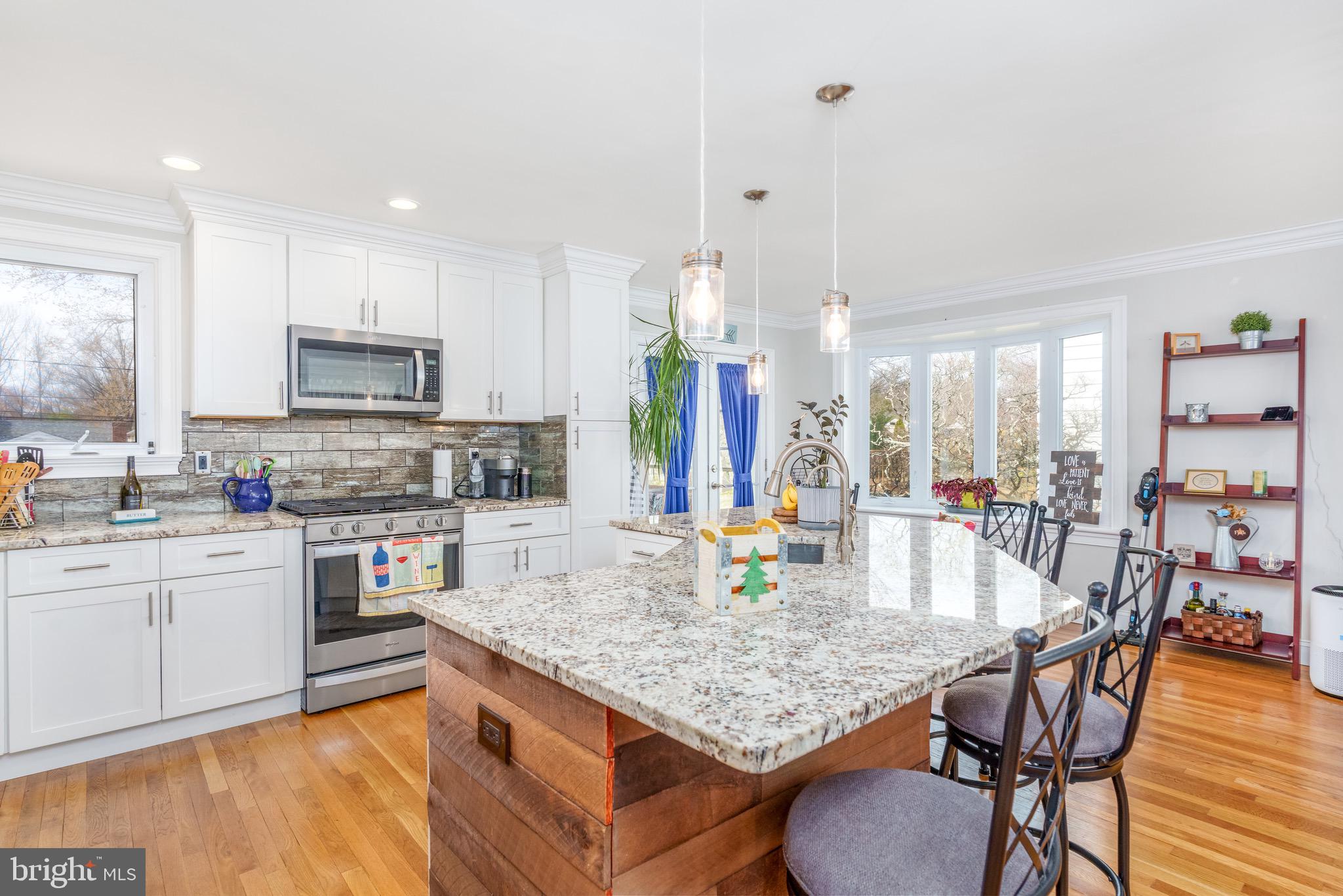 1003 Piper Road Wilmington, DE 19803 - Photo 11 of 40 a kitchen with stainless steel appliances granite countertop a stove top oven a sink a dining table and chairs