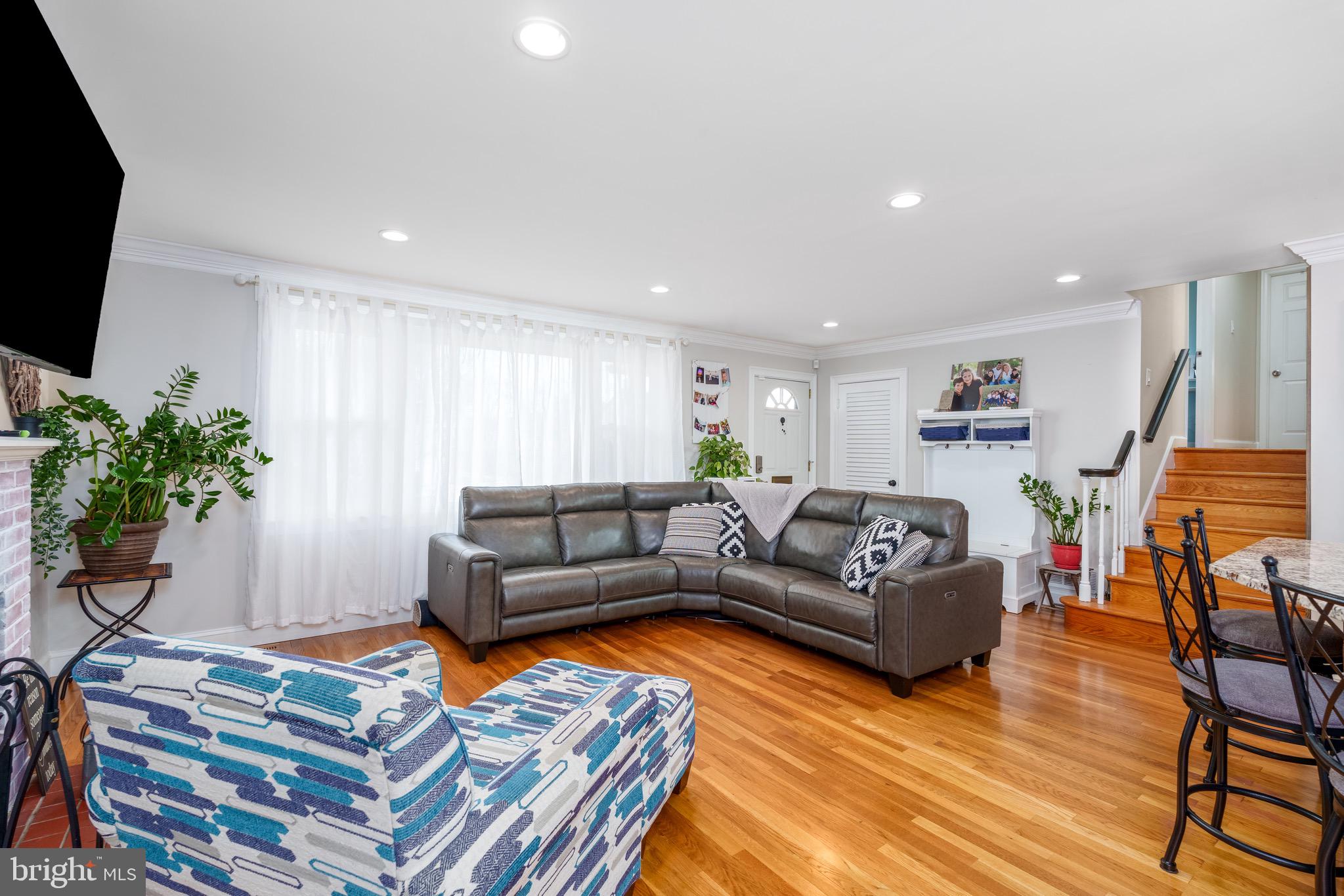 1003 Piper Road Wilmington, DE 19803 - Photo 12 of 40 a living room with furniture a flat screen tv and a potted plant