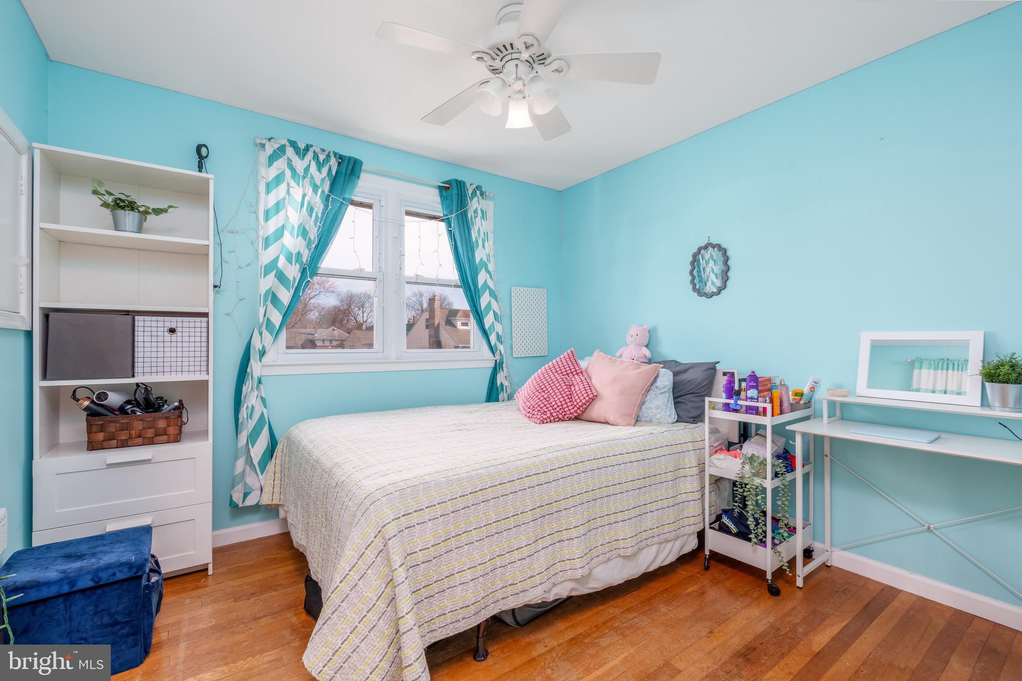 1003 Piper Road Wilmington, DE 19803 - Photo 13 of 40 a bedroom with a bed and a chandelier
