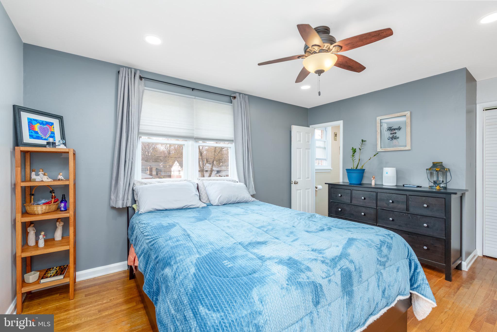 1003 Piper Road Wilmington, DE 19803 - Photo 17 of 40 a bedroom with a large bed and a chandelier