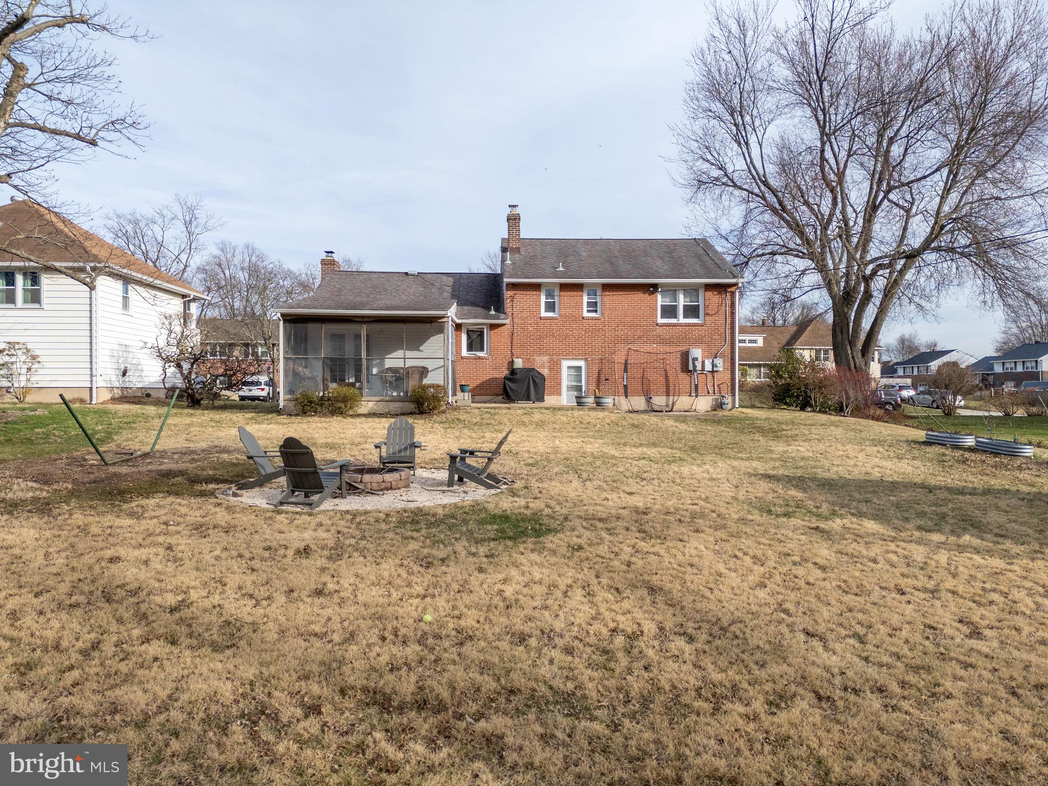 1003 Piper Road Wilmington, DE 19803 - Photo 29 of 40 a row of a brick house with large trees and cars parked in front of it