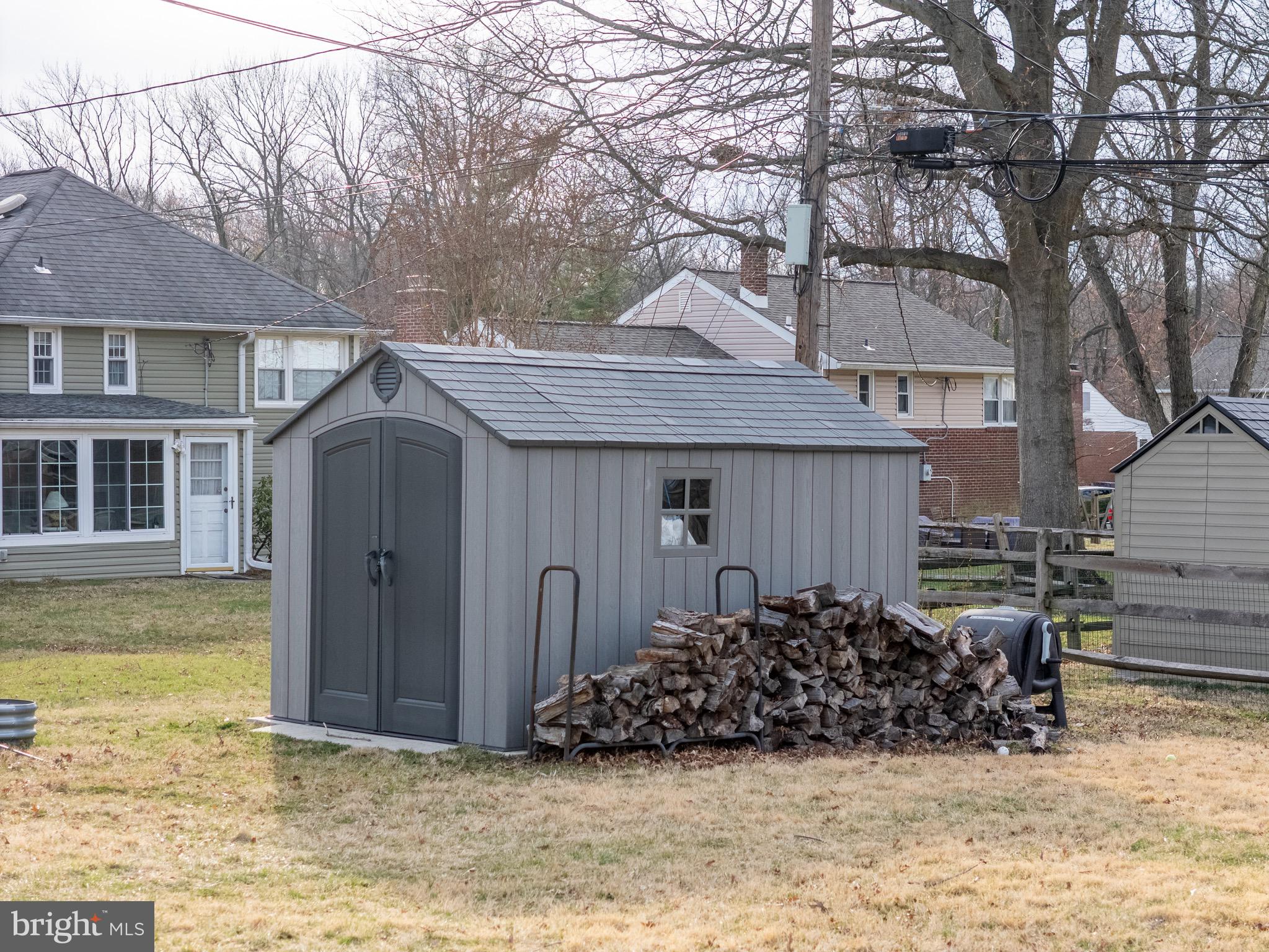 1003 Piper Road Wilmington, DE 19803 - Photo 35 of 40 a view of a house with a wooden fence and a large tree