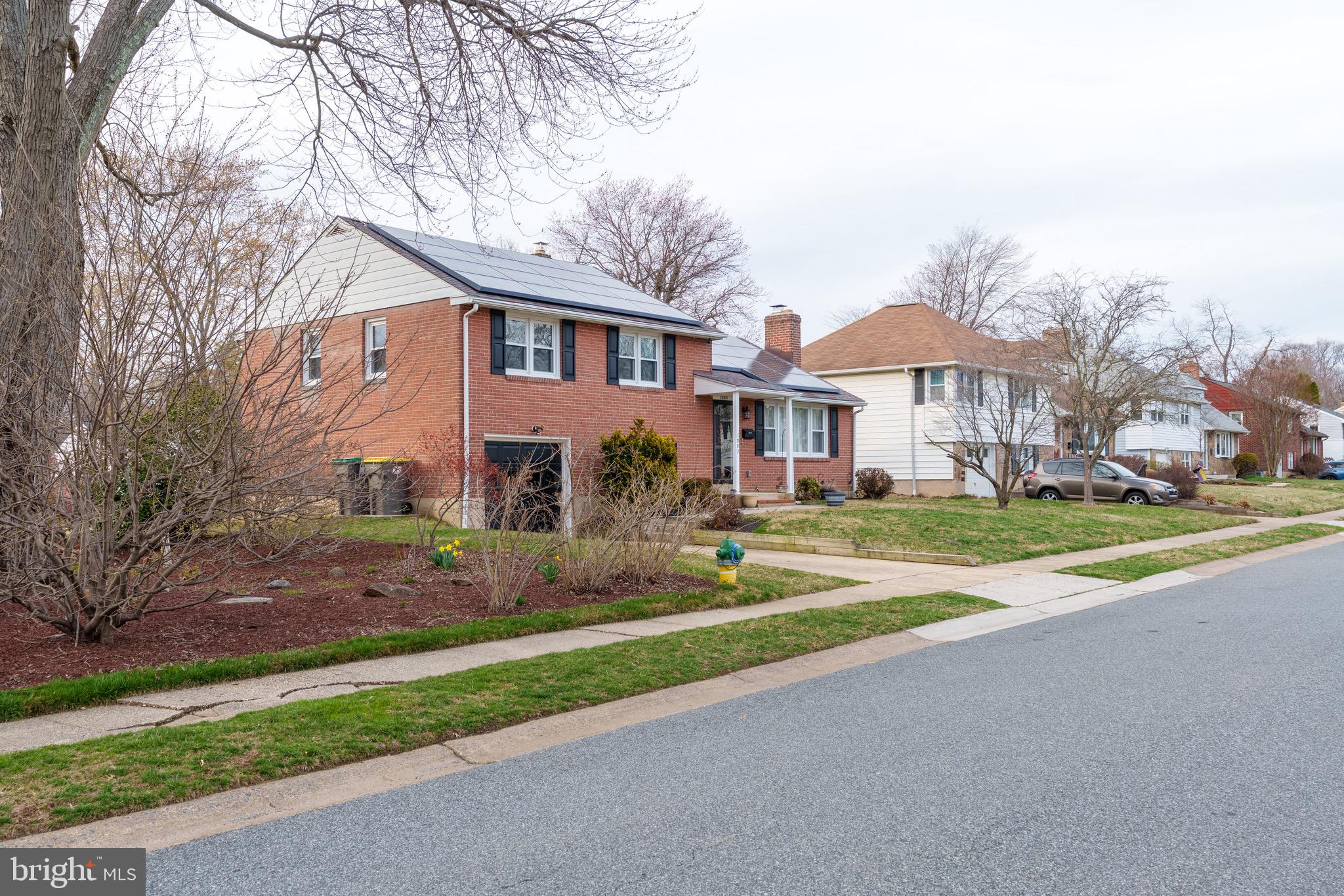 1003 Piper Road Wilmington, DE 19803 - Photo 38 of 40 a front view of a house with a yard and garage