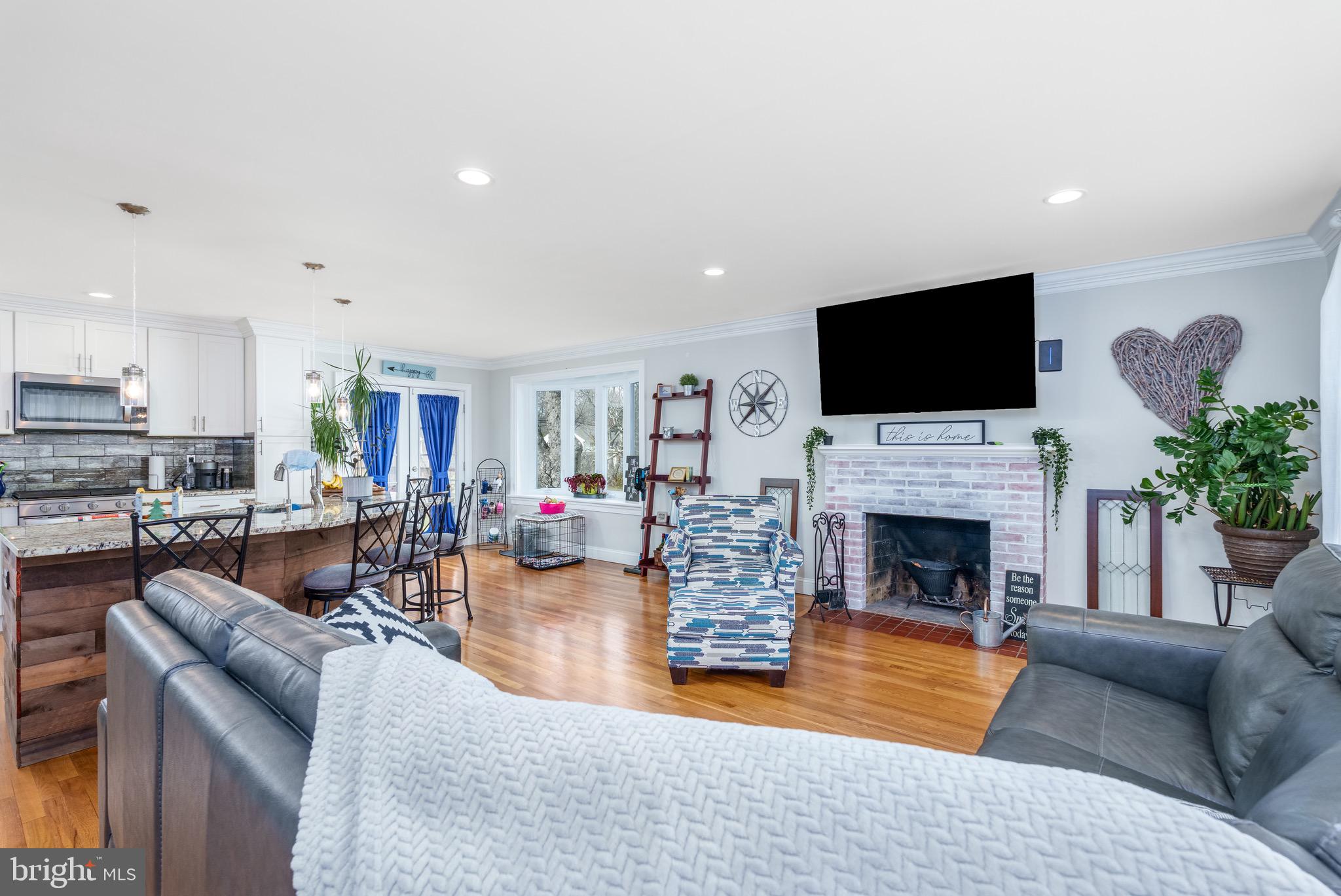 1003 Piper Road Wilmington, DE 19803 - Photo 7 of 40 a living room with furniture a fireplace and a flat screen tv