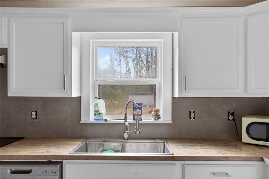 712 West 5th Highway Roopville, GA 30170 - Photo 11 of 29 a kitchen with a sink and cabinets