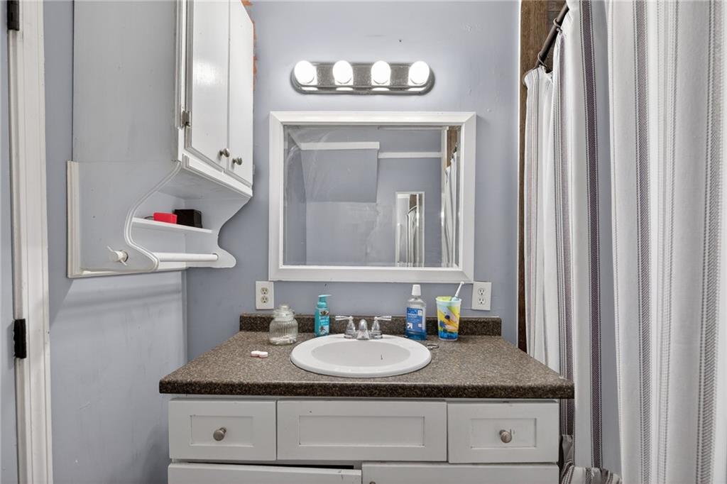 712 West 5th Highway Roopville, GA 30170 - Photo 14 of 29 a bathroom with a granite countertop sink and a mirror