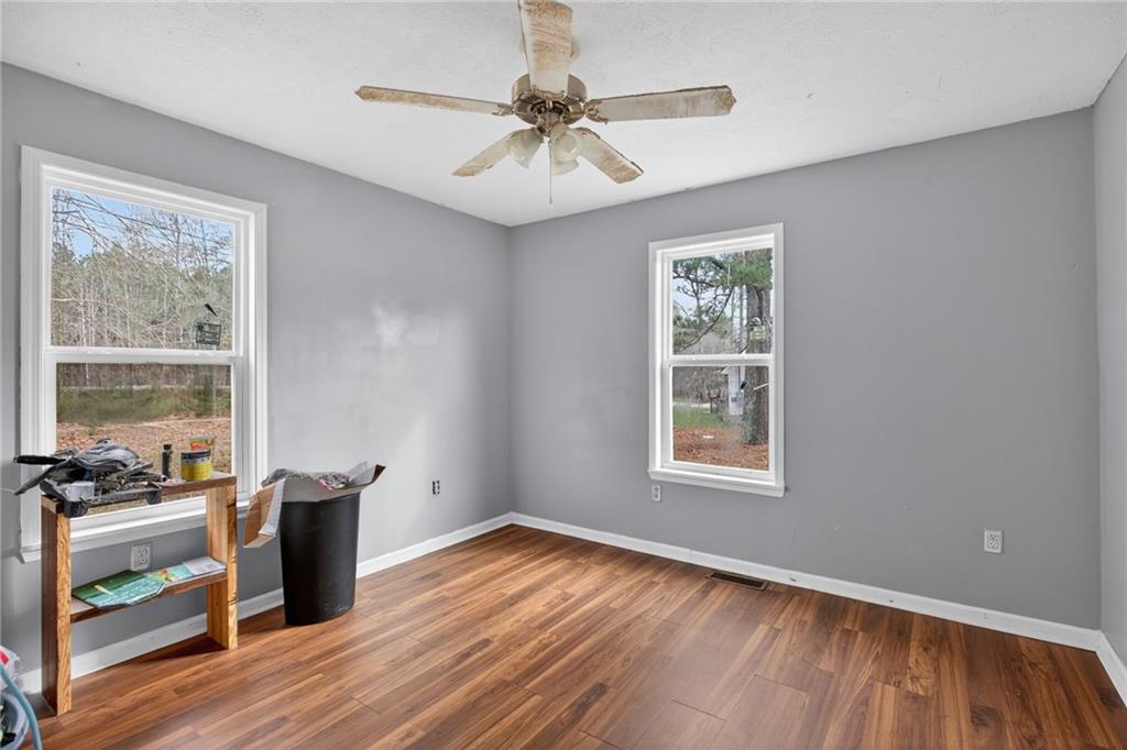 712 West 5th Highway Roopville, GA 30170 - Photo 15 of 29 a view of an empty room with a window and wooden floor
