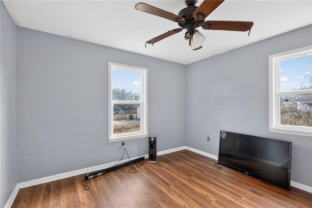 712 West 5th Highway Roopville, GA 30170 - Photo 16 of 29 a view of an empty room with window and wooden floor