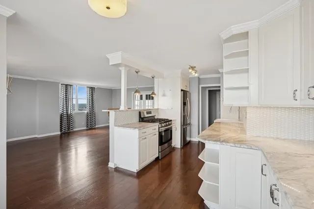 a kitchen with a refrigerator and a stove top oven
