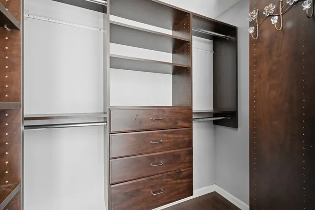 a view of walk in closet with empty racks