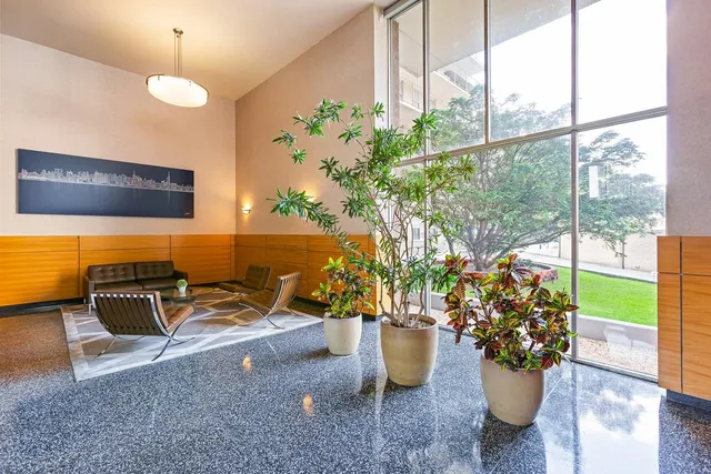 a dining room with furniture and a potted plant