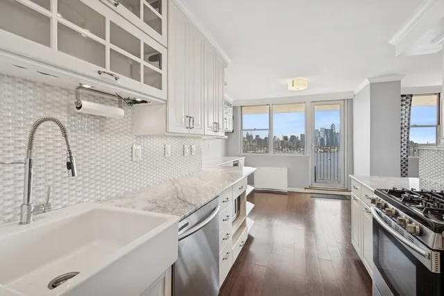 a kitchen with a sink a stove and cabinets