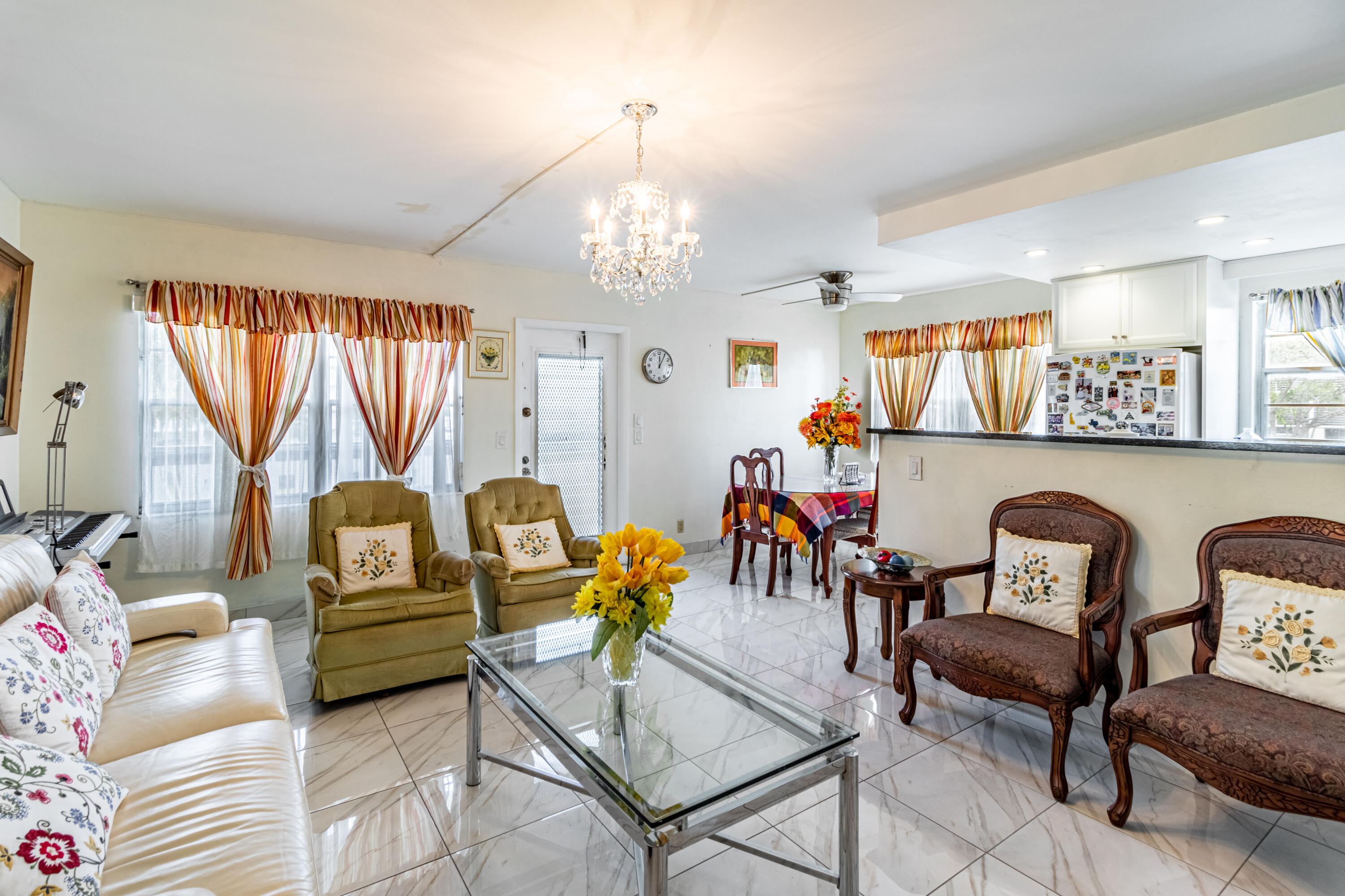 351 Mansfield I Boca Raton, FL 33434 - Photo 2 of 18 a living room with furniture and a chandelier