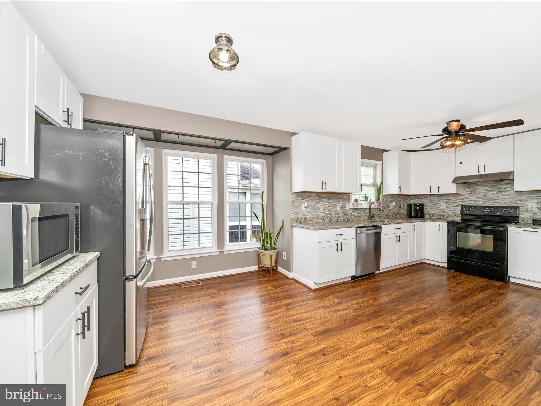 5004 Mallard Lane Frederick, MD 21703 - Photo 12 of 35 a large kitchen with stainless steel appliances granite countertop a stove and a sink
