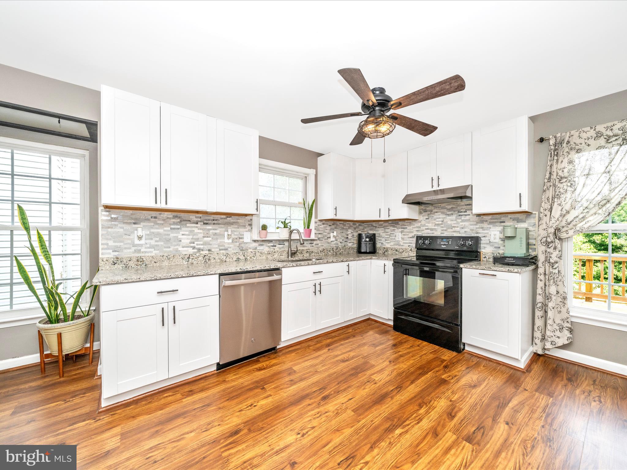 5004 Mallard Lane Frederick, MD 21703 - Photo 15 of 35 a kitchen with a stove a sink and white appliances