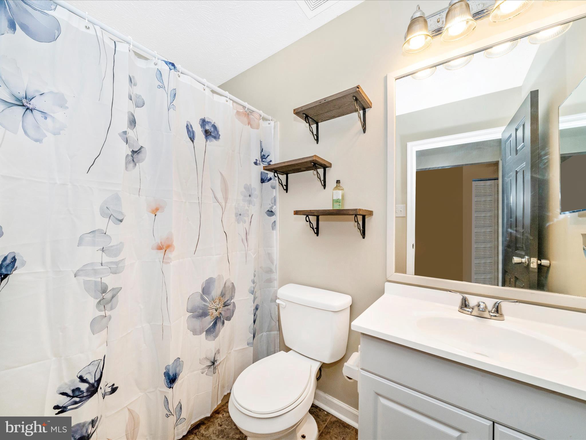 5004 Mallard Lane Frederick, MD 21703 - Photo 27 of 35 a bathroom with a granite countertop sink toilet and shower