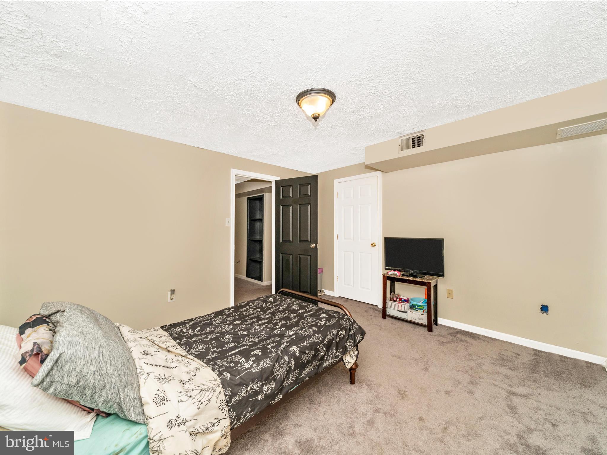 5004 Mallard Lane Frederick, MD 21703 - Photo 28 of 35 a bedroom with a bed and a television