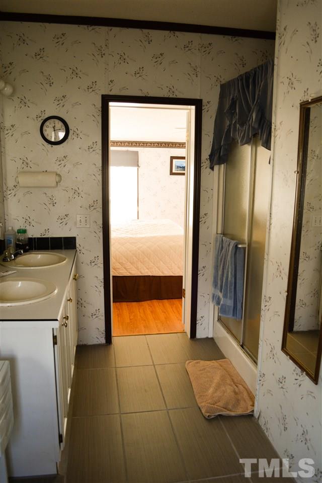 7236 Pecan Tree Street Willow Spring, NC 27592 - Photo 11 of 25 a bathroom with a sink a toilet and a shower