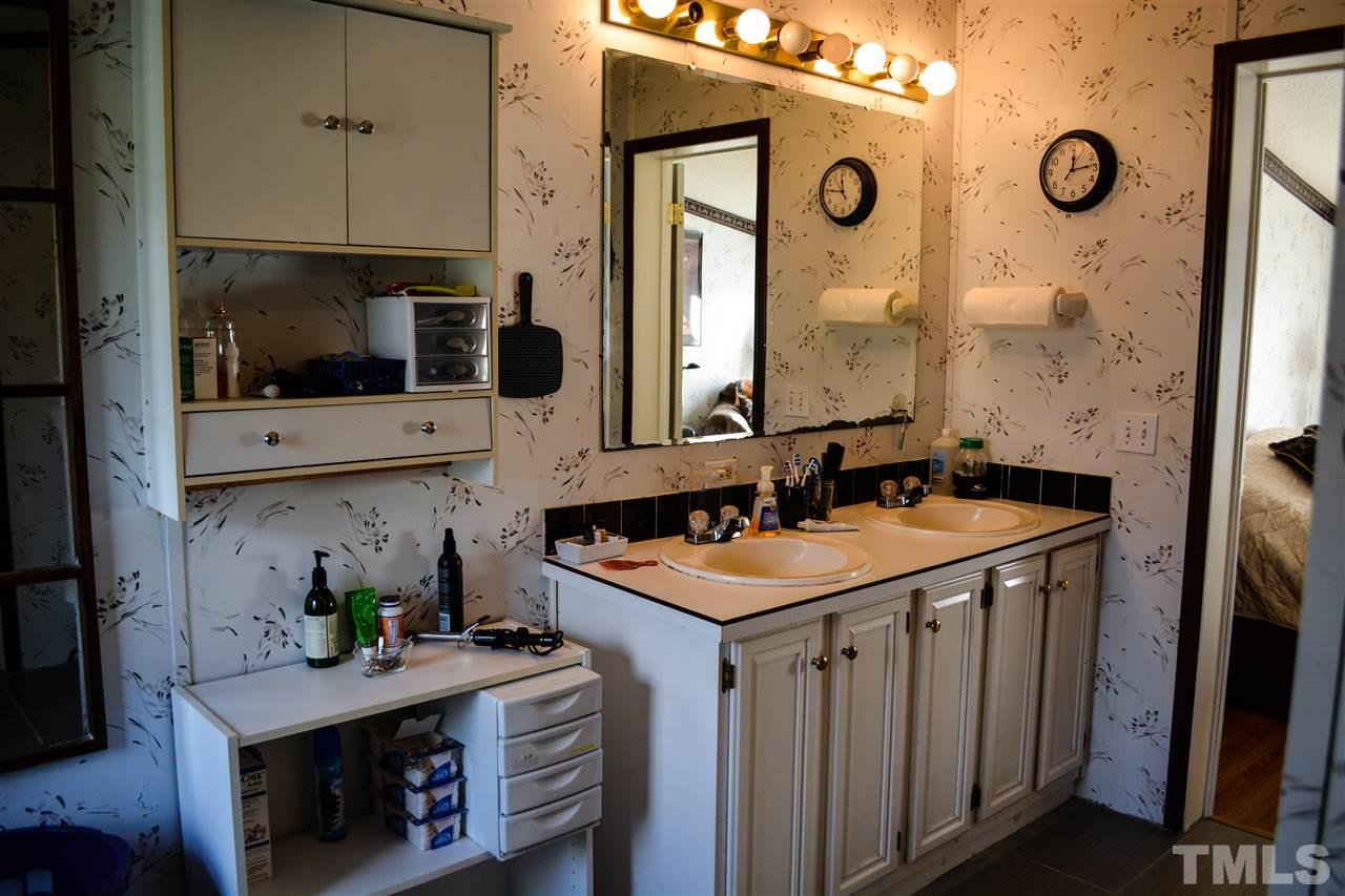 7236 Pecan Tree Street Willow Spring, NC 27592 - Photo 12 of 25 a bathroom with a granite countertop sink and a mirror