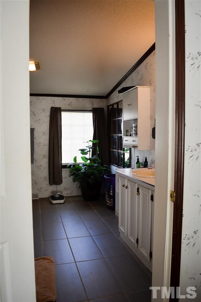 7236 Pecan Tree Street Willow Spring, NC 27592 - Photo 14 of 25 a kitchen with cabinets and window
