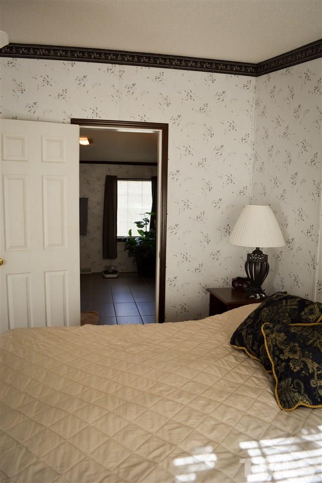 7236 Pecan Tree Street Willow Spring, NC 27592 - Photo 16 of 25 a bedroom with a bed and a mirror
