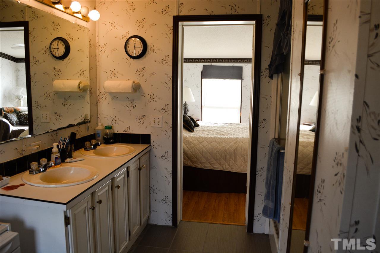 7236 Pecan Tree Street Willow Spring, NC 27592 - Photo 17 of 25 a bathroom with a sink and a mirror