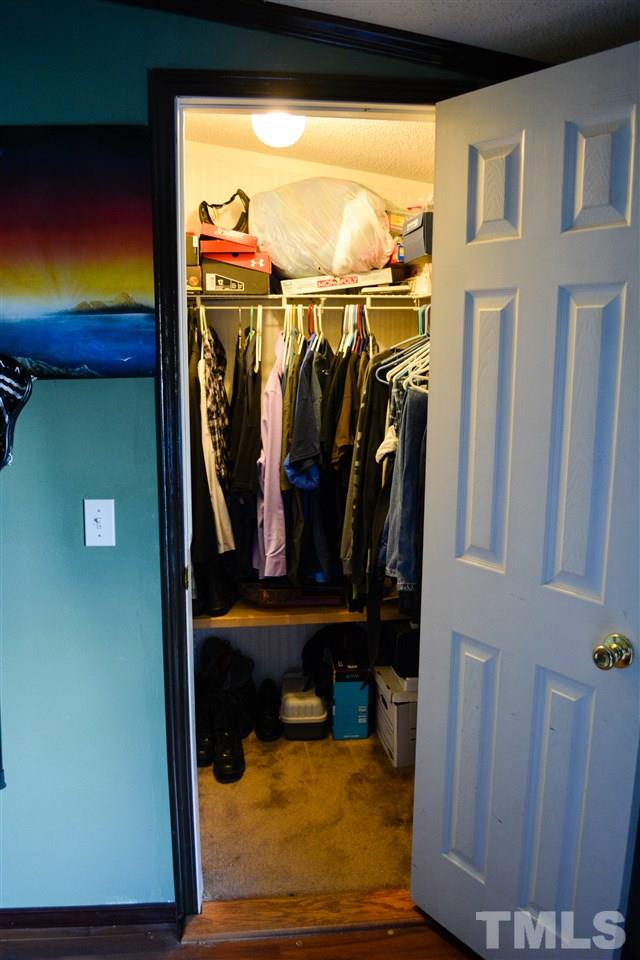 7236 Pecan Tree Street Willow Spring, NC 27592 - Photo 18 of 25 a view of walk in closet with clothes and shoes