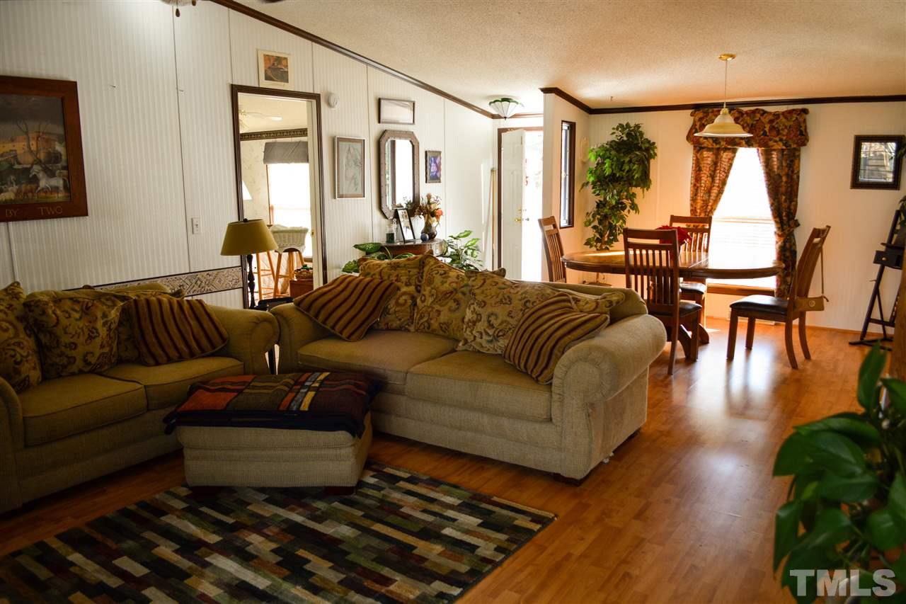 7236 Pecan Tree Street Willow Spring, NC 27592 - Photo 23 of 25 a living room with furniture and a large window