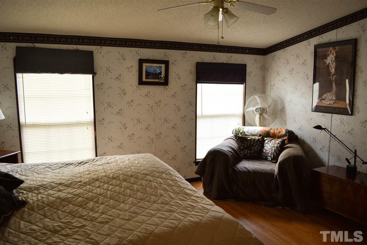 7236 Pecan Tree Street Willow Spring, NC 27592 - Photo 6 of 25 a bedroom with furniture and a window