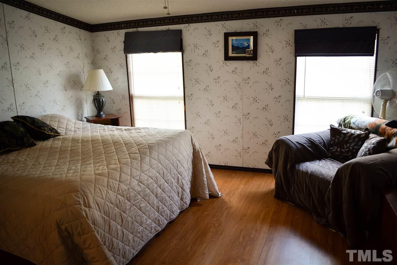 7236 Pecan Tree Street Willow Spring, NC 27592 - Photo 7 of 25 a bedroom with a bed and a window