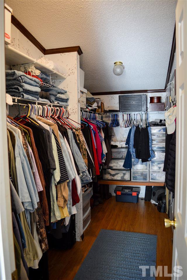 7236 Pecan Tree Street Willow Spring, NC 27592 - Photo 9 of 25 a view of walk in closet with clothes and shoes