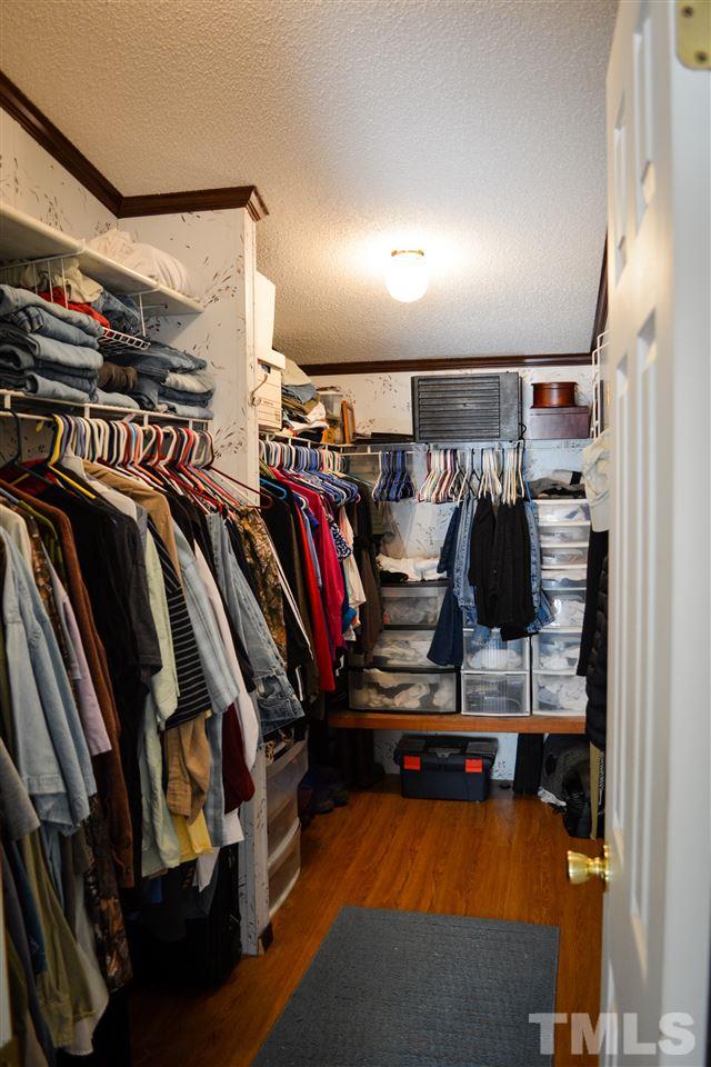 7236 Pecan Tree Street Willow Spring, NC 27592 - Photo 10 of 25 a view of walk in closet with clothes and shoes