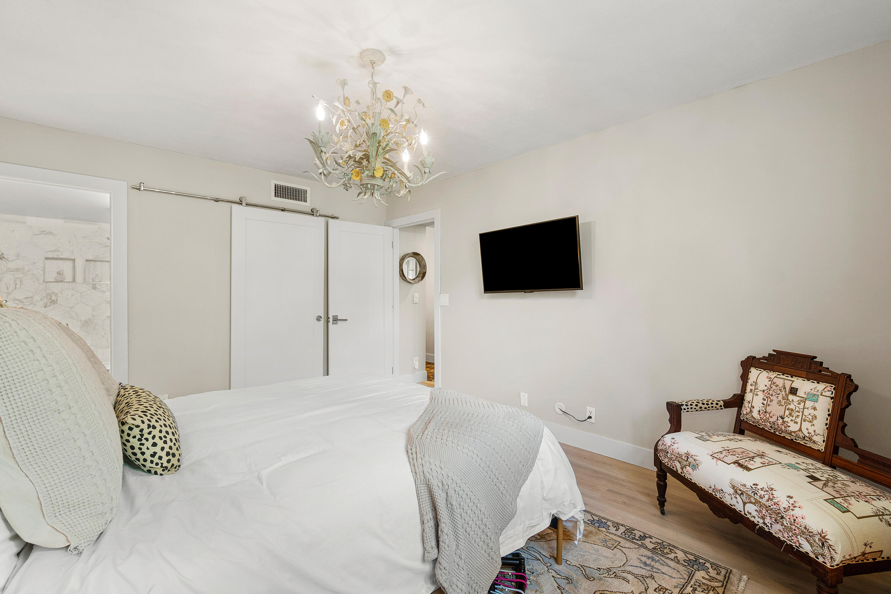 2805 Southwest 22nd Avenue, Unit 1040 Delray Beach, FL 33445 - Photo 12 of 18 a bedroom with a bed furniture and a flat screen tv