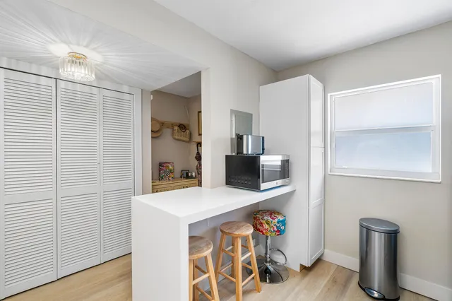 a kitchen with stainless steel appliances cabinets and wooden floor