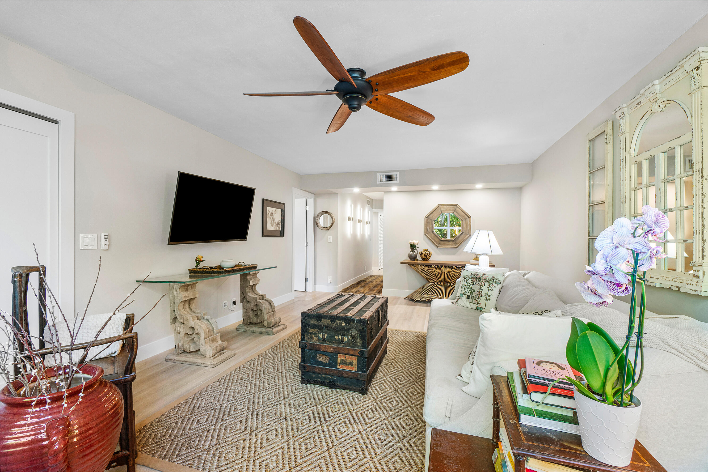 2805 Southwest 22nd Avenue, Unit 1040 Delray Beach, FL 33445 - Photo 9 of 18 a living room with furniture and a flat screen tv