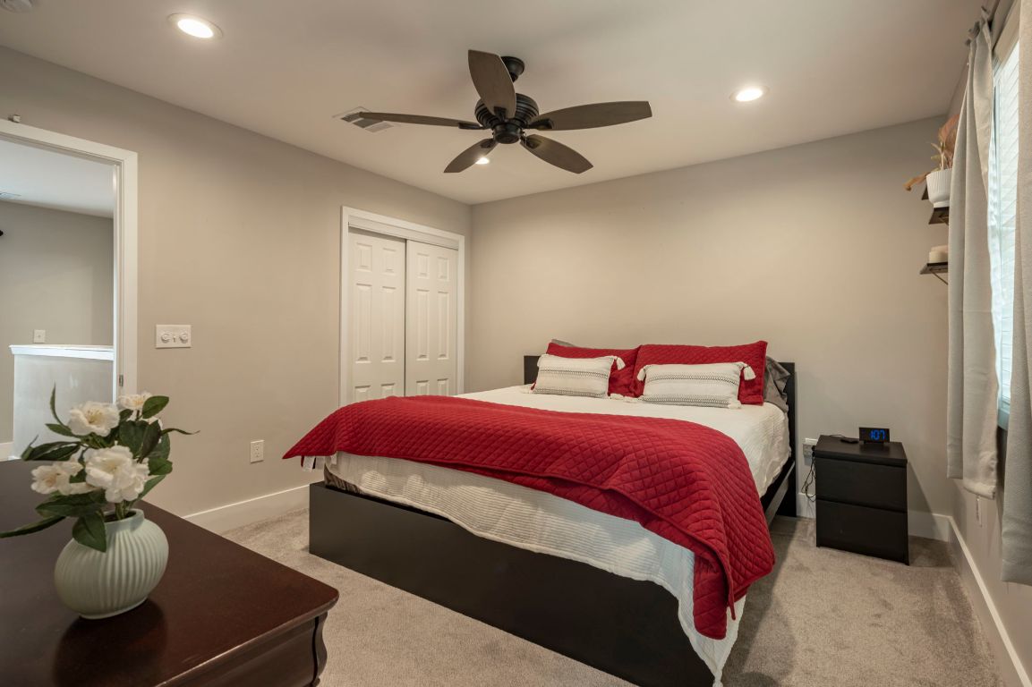 935 La Posada Drive, Unit 148 Austin, TX 78752 - Photo 20 of 29 a bedroom with a bed and a chandelier