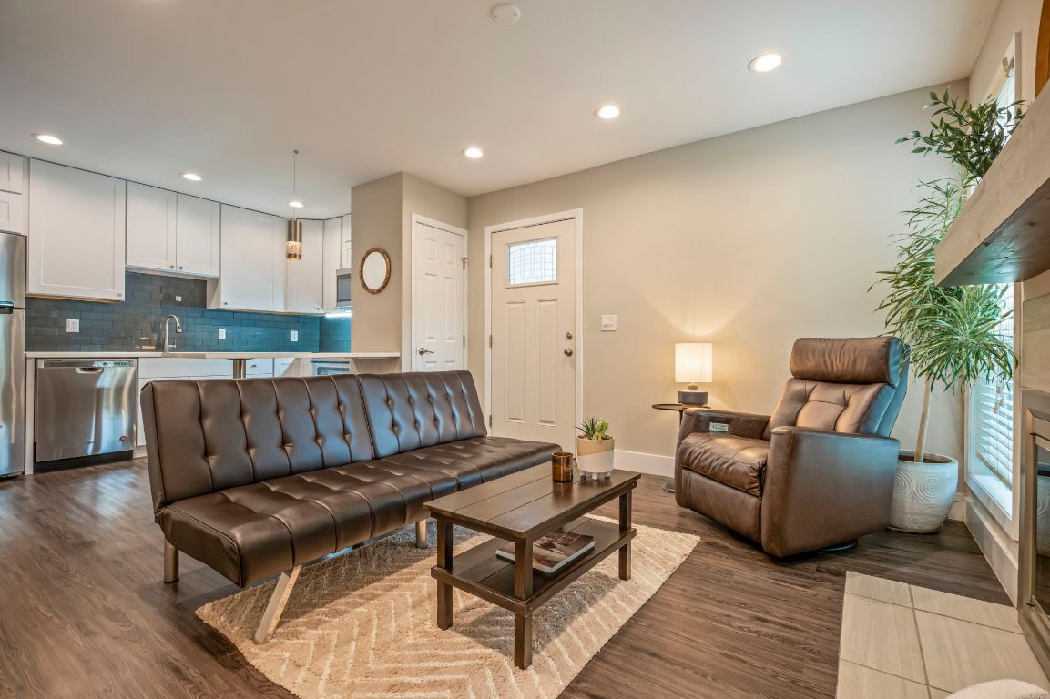 935 La Posada Drive, Unit 148 Austin, TX 78752 - Photo 2 of 29 a living room with furniture kitchen view and a potted plant