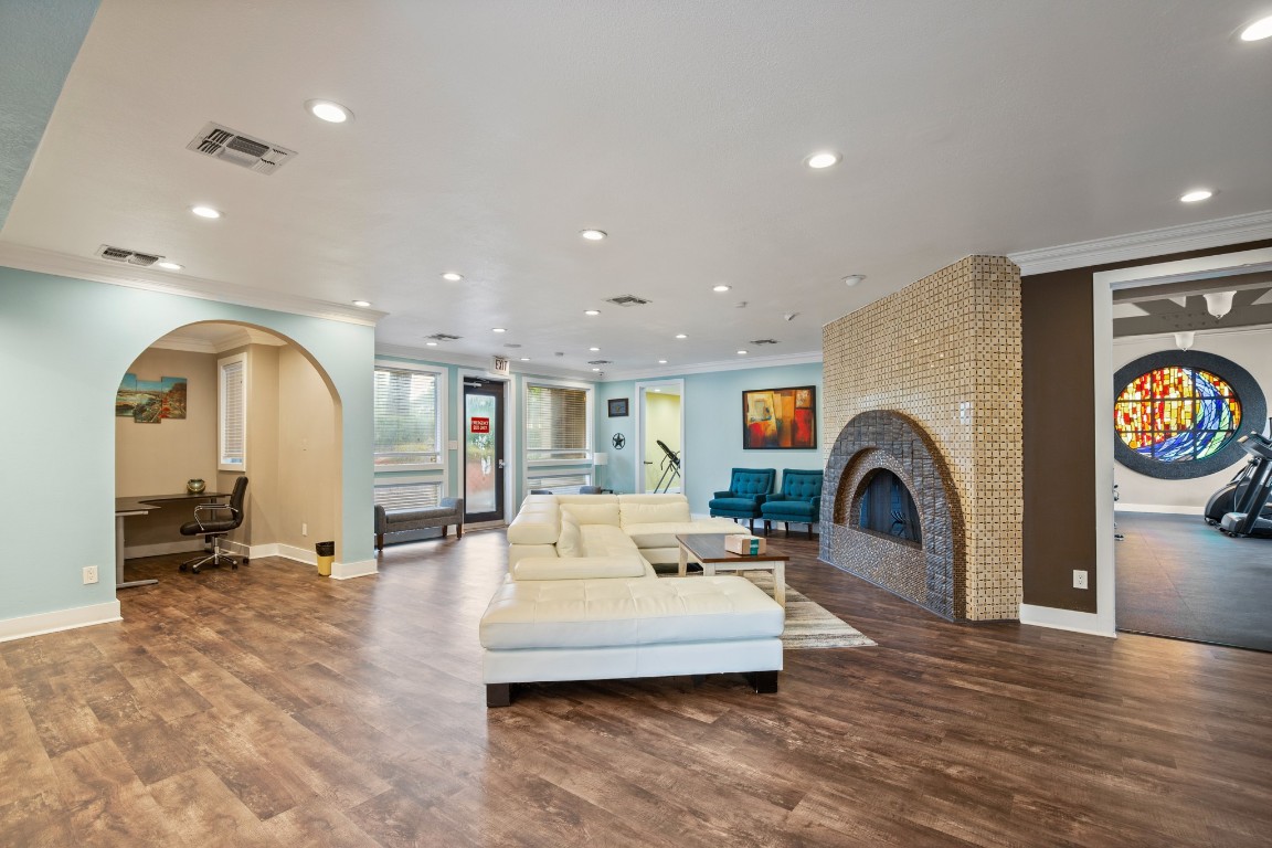 935 La Posada Drive, Unit 148 Austin, TX 78752 - Photo 27 of 29 a living room with furniture a mirror and a fireplace