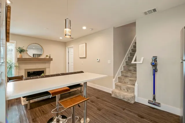 a living room with furniture a flat screen tv and wooden floor