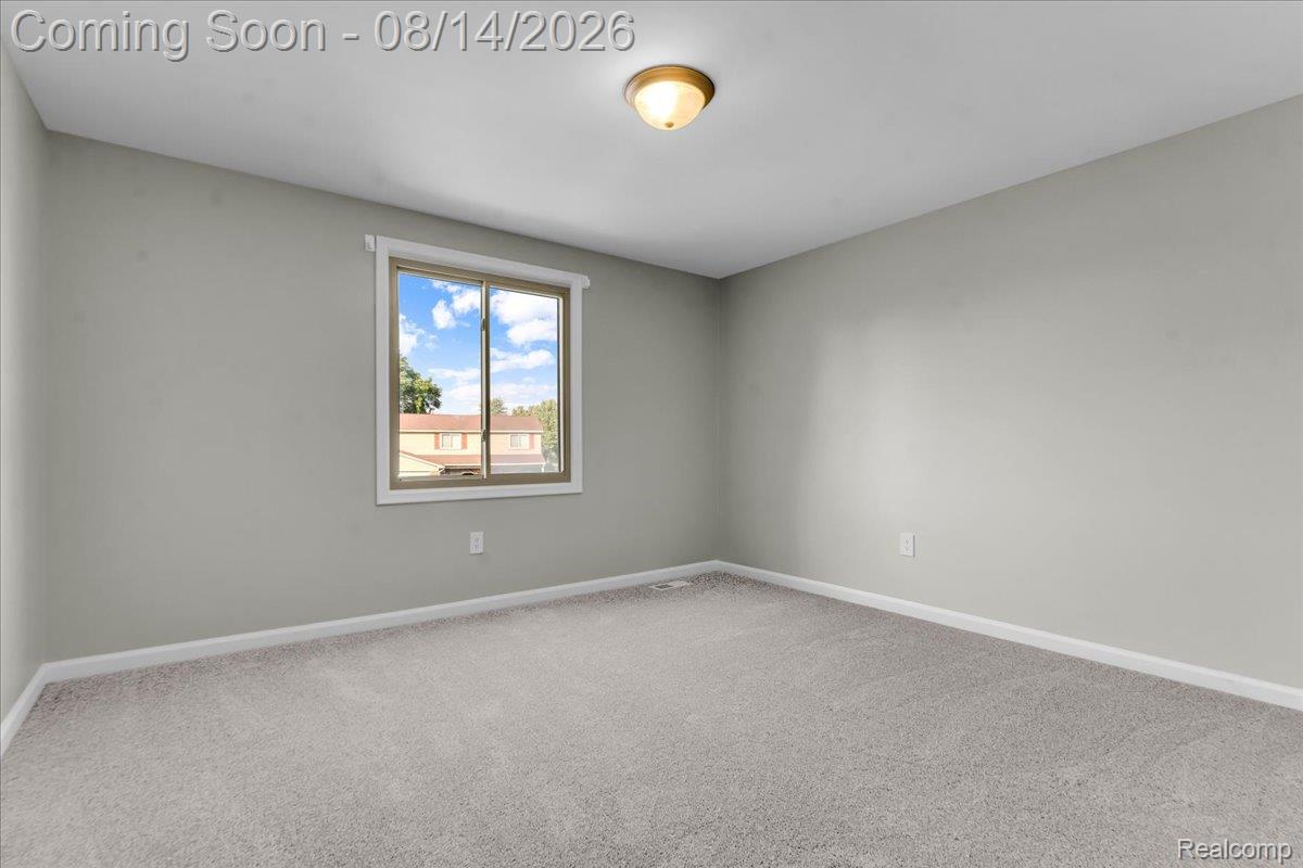 47321 Susan Road Macomb, MI 48044 - Photo 29 of 46 Neutral tone walls, plush carpeting, ceiling-mounted light fixture, and window with white trim