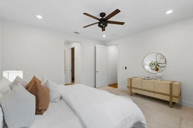 a bedroom with bed and a chandelier