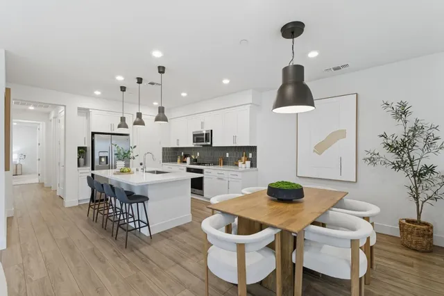 a kitchen with a table and chairs in it