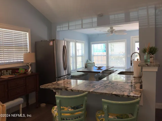 a kitchen with sink and refrigerator