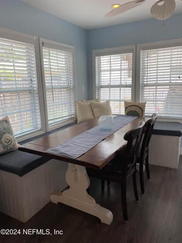 a view of a dining room with furniture and window