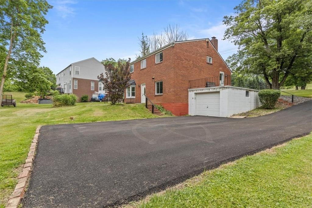 301 McCombs Road Venetia, PA 15367 - Photo 32 of 37 a view of a house with a yard and garage